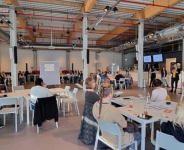 Foyer des Badischen Staatstheaters mit Teilnehmenden an Gruppentischen im Zuge des Runden Tisch Antirassismus / Antidiskriminierung am 10. Oktober 2022
